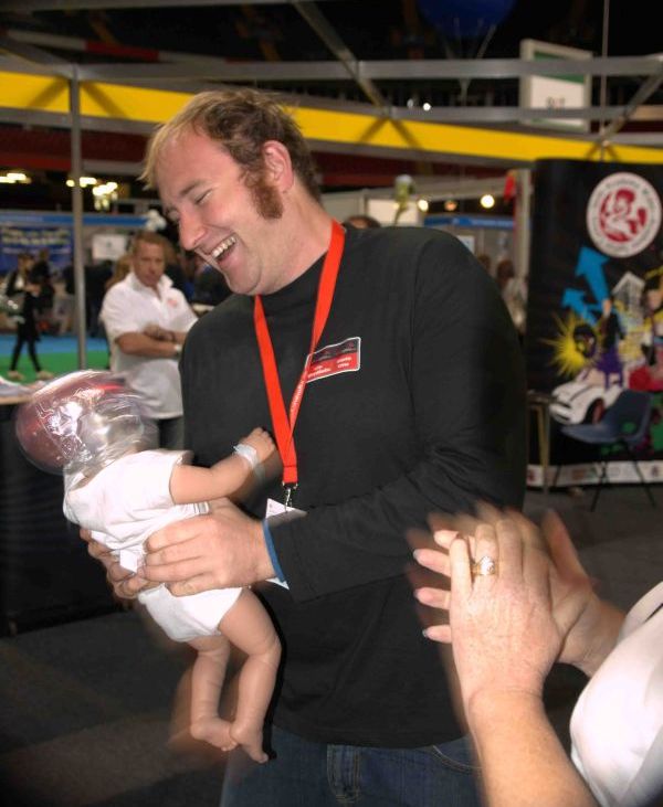 Josh Nimmo shaking a doll